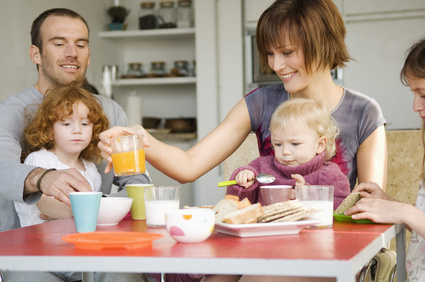 Couple and 3 children at breakfast table © fotolia